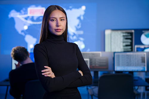 Female Cybersecurity Analyst or Manager in large Cyber Security Operations Center SOC handling Threats