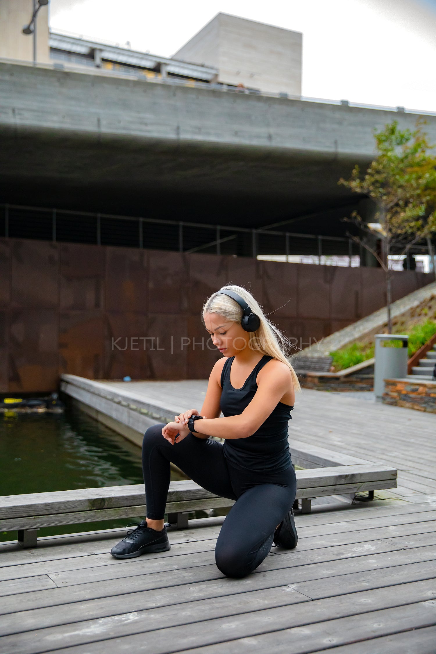 Sporty Fit Female Runner Listening Music and Using Smartwatch