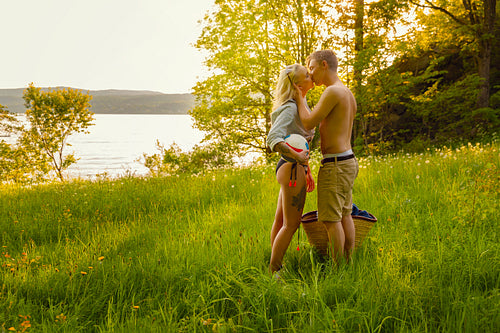 Young Man Kissing Girlfriend During Sunset in Beautiful Environment