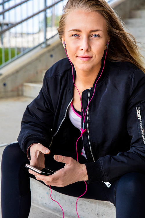 Attractive Woman In Sportswear Listening Music On Smartphone