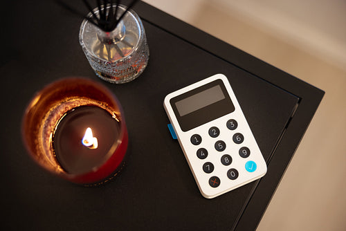 White Card Reader By Tealight On Table