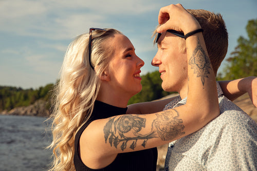 Playful Young Blond Woman Looking At Smiling Boyfriend