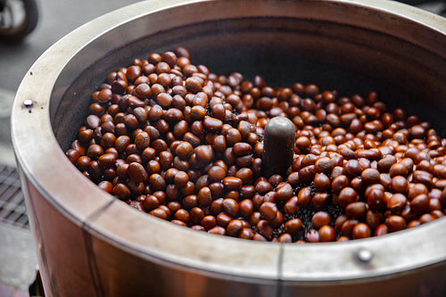 Roasting Brown Chestnuts In Big Pot At Local Street Market