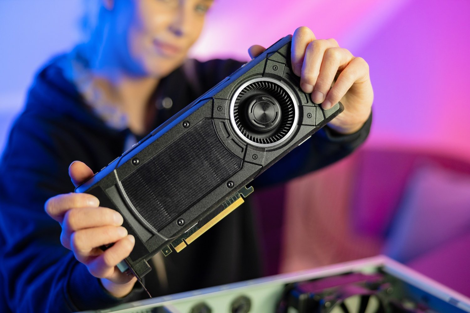 Gamer Girl Holding a New GPU Video Card in Her Hands