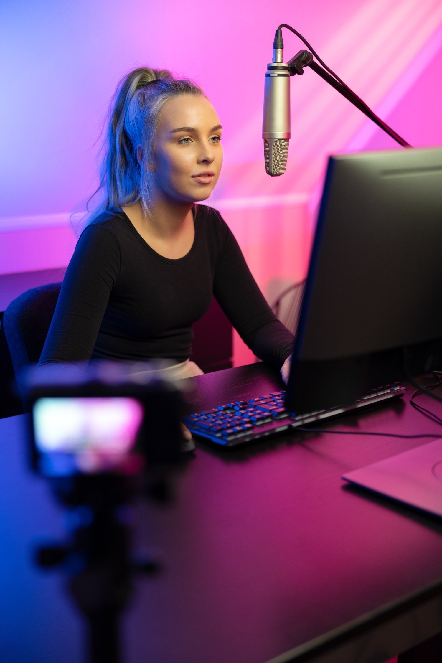 Professional e-sport gamer girl streaming and plays online video game on PC